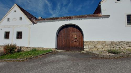 a white church with a large wooden door on it at Prázdninový dům in Habří