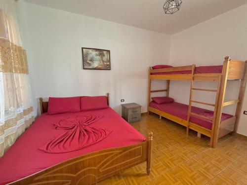 a bedroom with a bed and bunk beds in it at Hotel Martini in Velipojë