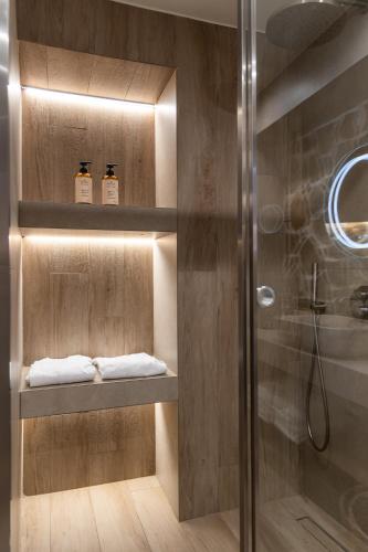 a bathroom with a shower with two bottles of soap at Aqua Pearl Milos in Adamantas