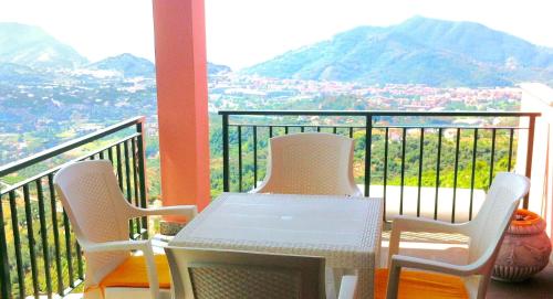 zwei Stühle und ein Tisch auf einem Balkon mit Aussicht in der Unterkunft Villa Mari - Collina Sestri Levante Splendida vista in Sestri Levante