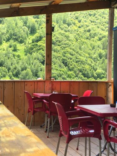 a group of tables and chairs on a deck at Ela in Ushguli
