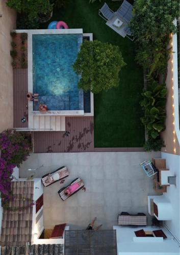 an overhead view of a house with people laying on the ground at Can Vilàs in Muro