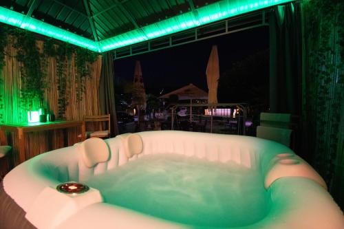 a bath tub in a room with green lights at Wellness am Rheinufer in Remagen