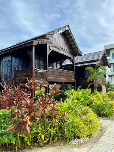 a house with a lot of plants in front of it at Landmark Cenang in Pantai Cenang