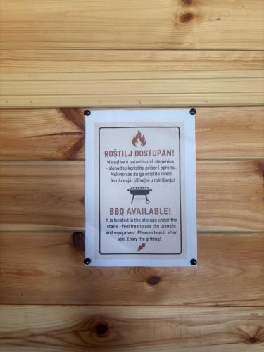 a sign hanging on a wooden wall at Hush Chalet Durmitor in Žabljak
