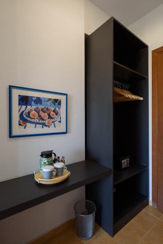 a black counter with a plate of food on a shelf at City Gate Hotel Airport Thessaloniki in Thessaloniki