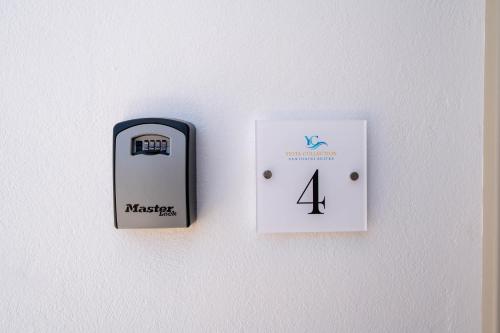 a couple of switches on a white wall at NEW Yiota Collection 4 Suites & 4 Prive Jacuzzi in Megalokhori
