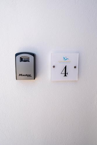 a clock on a wall with the number four at NEW Yiota Collection 4 Suites & 4 Prive Jacuzzi in Megalokhori