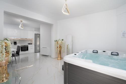 a bathroom with a large tub in a kitchen at NEW Yiota Collection 4 Suites & 4 Prive Jacuzzi in Megalokhori