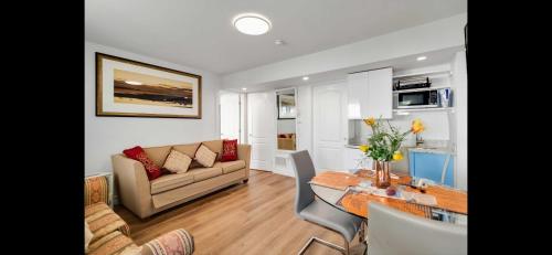 a living room with a couch and a table at Entire Cozy Apartment with Share Jacuzzi to Enjoy Amazing Views in Halifax