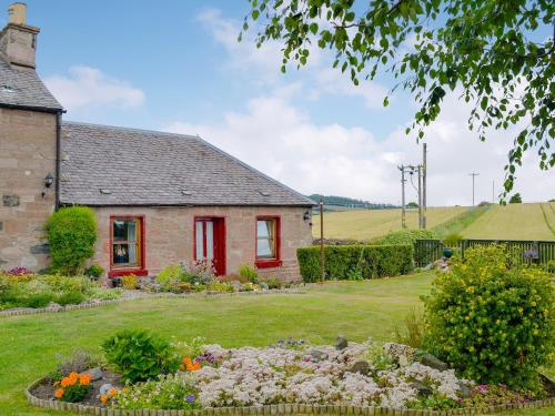 a brick house with a garden in front of it at Laurel Bank in Alyth