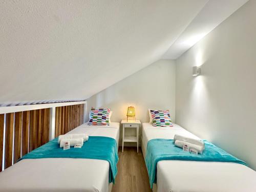 two twin beds in a room with at Vilamoura Marina View 4 by Homing in Vilamoura