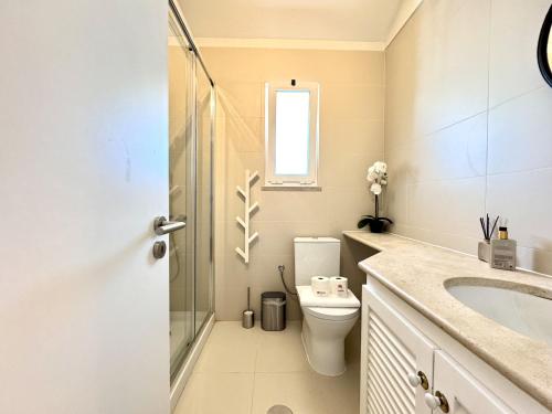 a bathroom with a toilet and a sink at Vilamoura Marina View 4 by Homing in Vilamoura