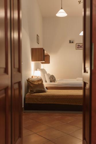 a bedroom with a bed with a lamp on it at Hotel Anna Villa in Balatonföldvár