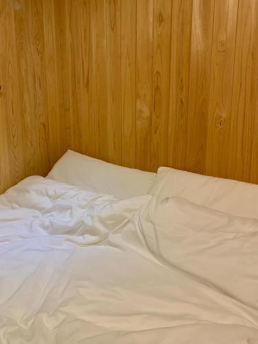 an unmade bed with white sheets and two pillows at 스테이 편차 in Pyeongchang 