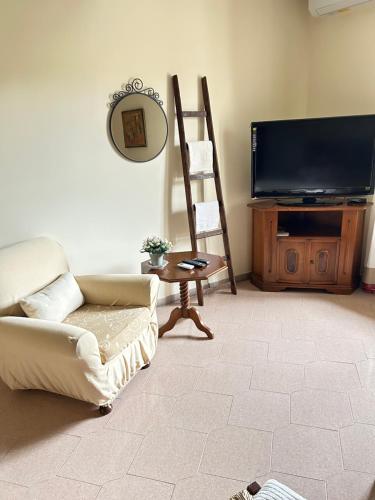 a living room with a couch and a television at Antica Casa Sabina in Torri in Sabina