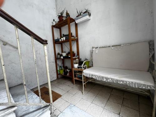 a small room with a bed and a shelf at La casa di Sarah aspetta voi in Naples