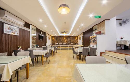 a dining room with tables and chairs in a restaurant at A25 Hotel - 12 Ngô Sỹ Liên in Hanoi