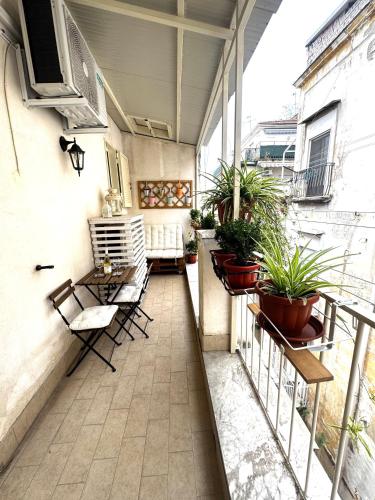 a balcony with chairs and plants on a building at La casa di Sarah aspetta voi in Naples
