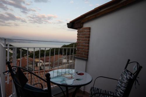 a small table on a balcony with a view of the ocean at B&b Rosaria sea view in Vietri sul Mare