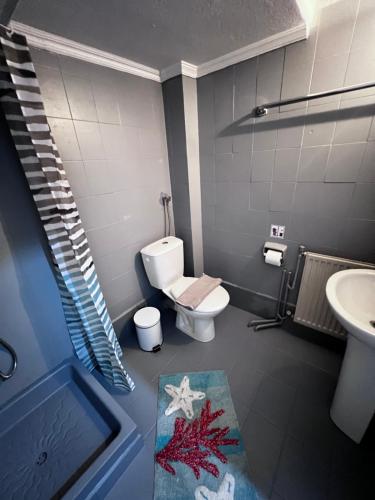 ein Badezimmer mit Toilette und Waschbecken in der Unterkunft Almond Apartments Sun and Sea in Asprovalta