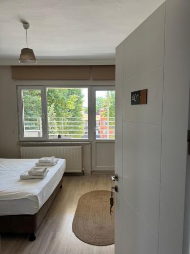 a white room with a bed and a window at Well Hotel Edirne in Edirne