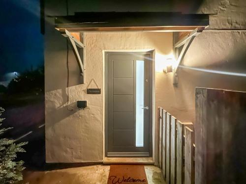 a door on the side of a house at night at The Annexe in Guilsfield