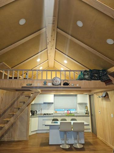 a kitchen with a staircase with two chairs and a table at 스테이 편차 in Pyeongchang 