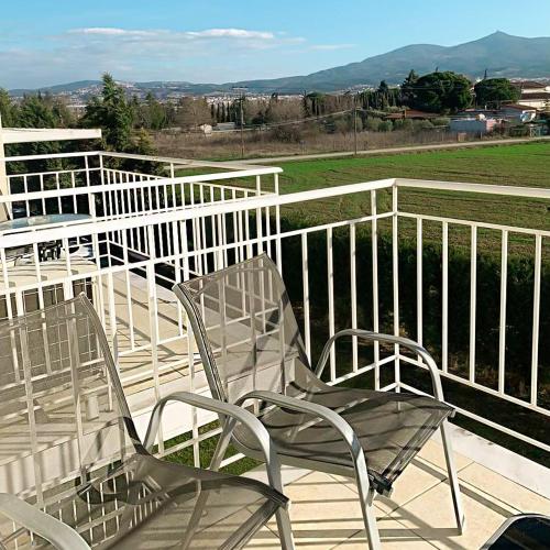 two chairs sitting on top of a deck at City Gate Hotel Airport Thessaloniki in Thessaloniki