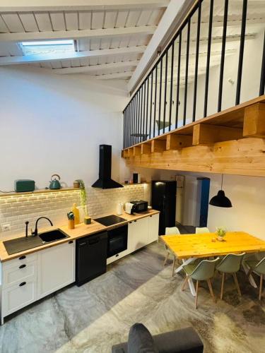 a kitchen with white cabinets and a yellow table at Casa das Andorinhas-Alentejo in Vidigueira