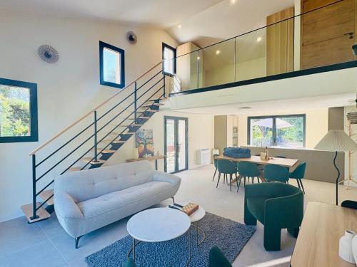 a living room with a couch and a table at L'Esprit Sud, 4 Suites & Piscine in Vence