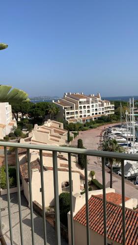 a balcony with a view of a beach and buildings at Duplex sur le Golfe de Saint Tropez - Panoramic View in Cogolin