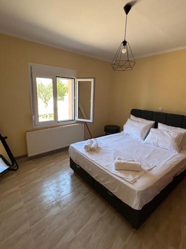 a bedroom with a large bed with white sheets at Phoenix Apartment in Xanthi