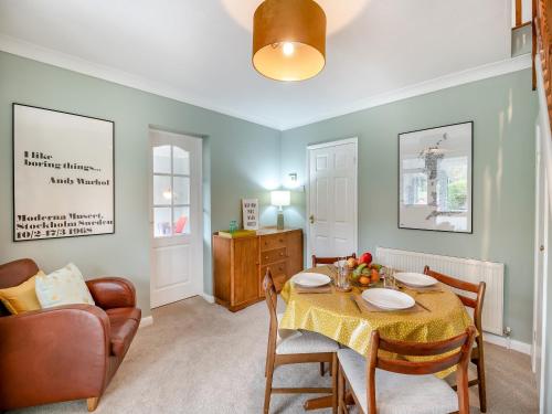 a living room with a table and a chair and a couch at Hill View in Pateley Bridge