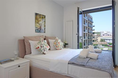 a bedroom with a large bed with a large window at New Luxury Dorcol Downtown Apartment in Belgrade