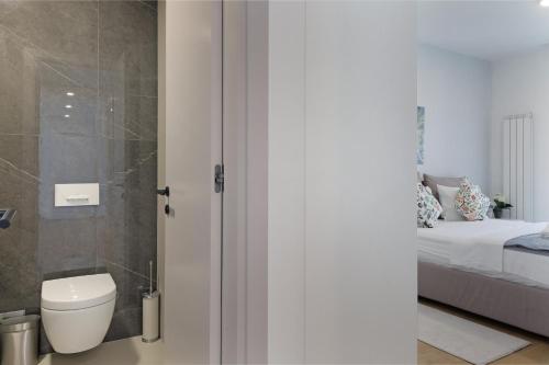 a bathroom with a shower and a toilet and a bed at New Luxury Dorcol Downtown Apartment in Belgrade