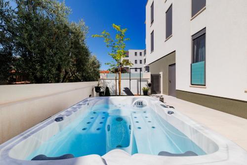 a hot tub on the roof of a house at Latitude 44 Apartment in Zadar