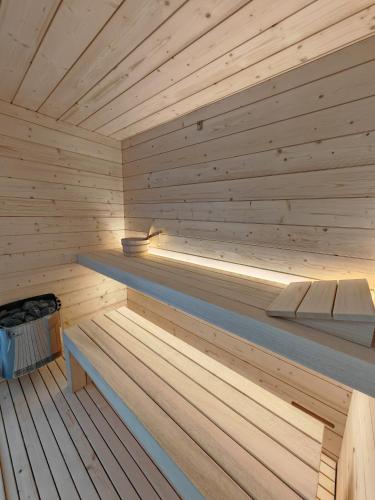 a wooden sauna with a bench in it at Alloggi Tosca Airport Lodges in Ronchi dei Legionari