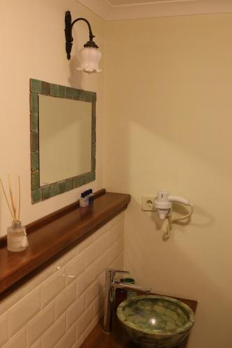 a bathroom with a sink and a mirror on the wall at Gizemli Konak in Ayvalık