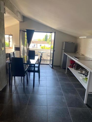 a kitchen and dining room with a table and chairs at Relax Apartments Grazia in Funtana