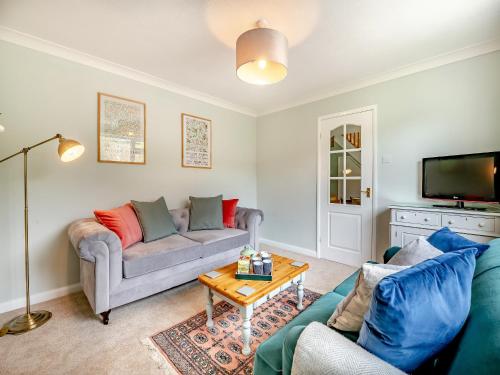 a living room with a couch and a table at Hill View in Pateley Bridge