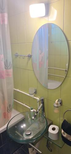 a bathroom with a glass sink and a mirror at Uroš in Bački Petrovac
