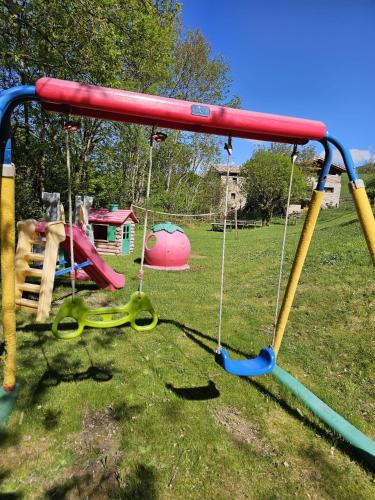 a swing set on a playground in a park at La Masia del Batlle in Sarroqueta