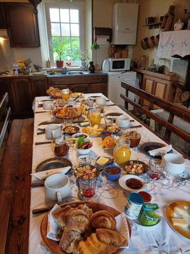 a table with many plates of food on it at Oudoty in Kerlouan