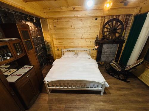 a bedroom with a bed in a wooden room at Alashkert Guesthouse ,Ալաշկերտ Հյուրատուն in Gyumri