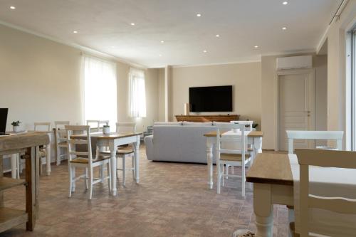 a living room with a couch and tables and chairs at il Frutteto in Pietrasanta