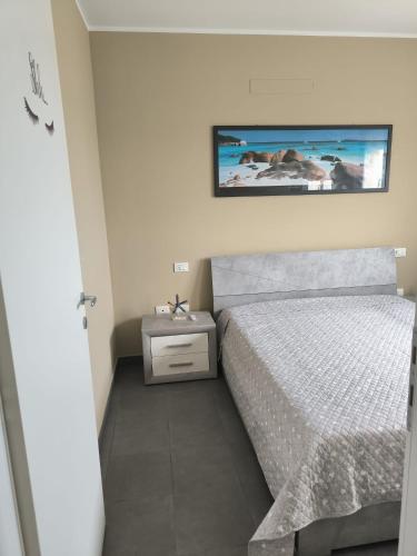 a bedroom with a bed and a tv on the wall at Casa Cleo in Tortoreto Lido