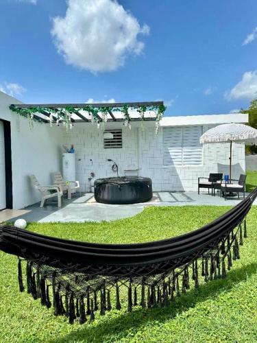 a hammock in the middle of a yard at Anime Escape with Private Jacuzzi & Themed Rooms 