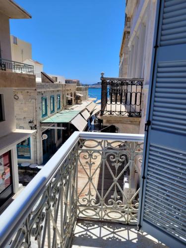 an apartment balcony with a view of the water at Agora apartment in Ermoupoli