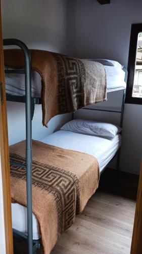 three bunk beds with towels on top of them at Camping Alpino - Nature Village in Malcesine